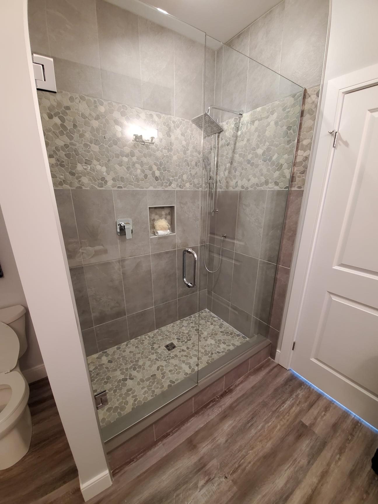 Custom shower with pebble mosaic accents