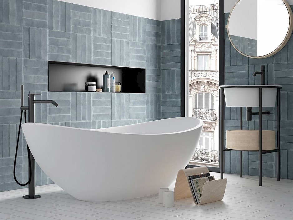 Freestanding tub with stacked blue grey wall tile