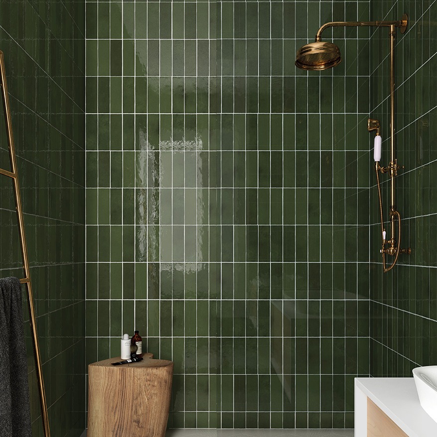 Green subway tile shower with brass fixtures